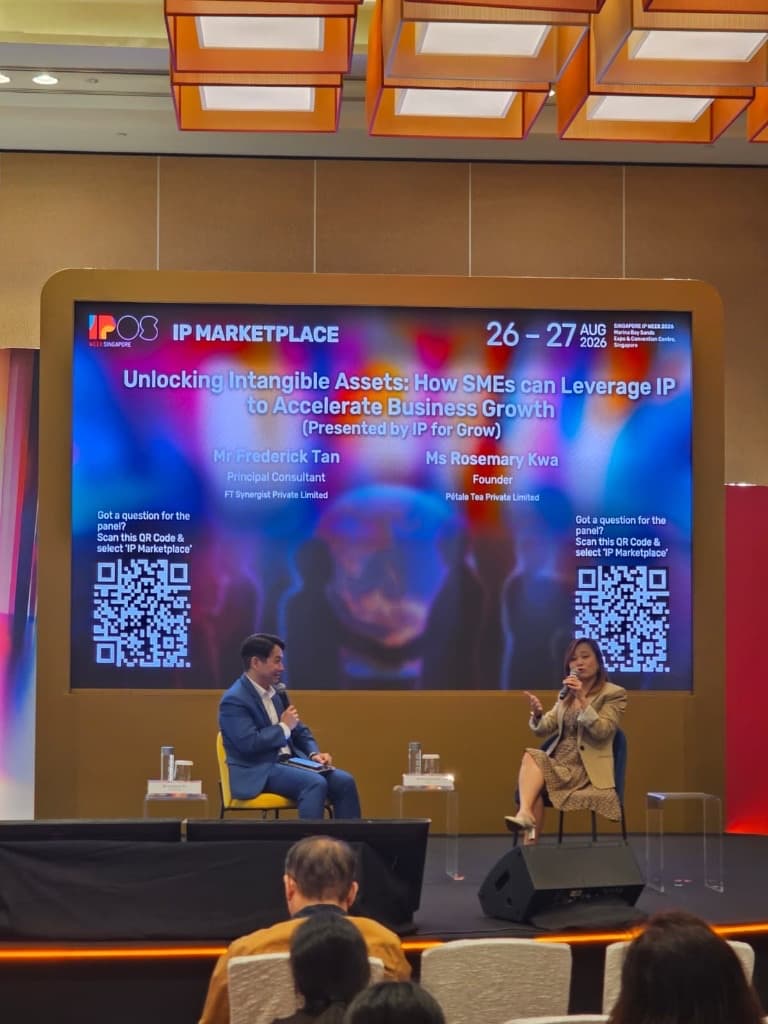 IPOS IP Marketplace 2026 stage backdrop featuring Frederick Tan and Rosemary Kwa